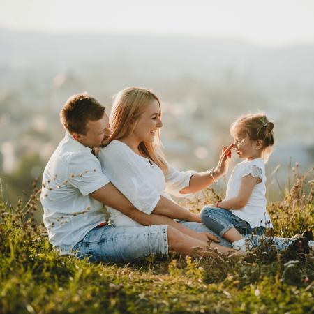 happy-parents-their-little-girl-rest-lawn-beautiful-summer-day